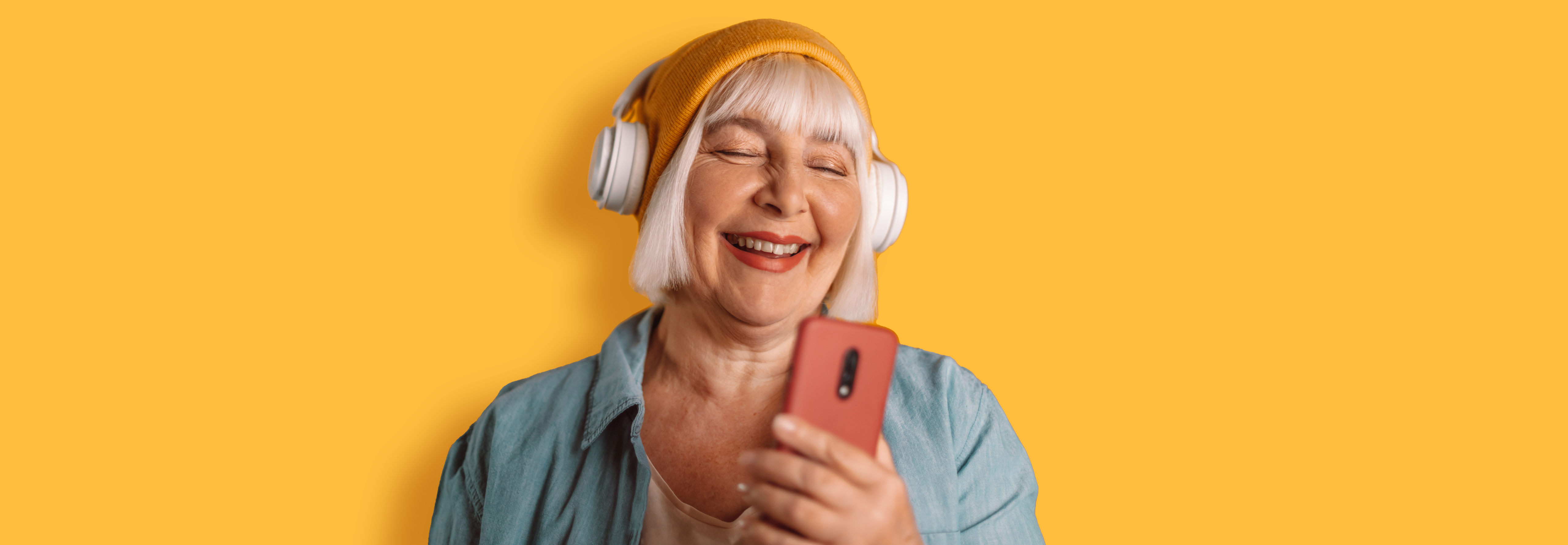 woman holding phoone - yellow background page wide